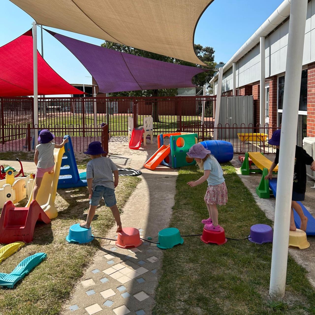 Children using outdoor play equipment